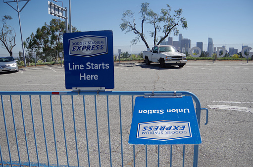 Los Angeles.U.S.A - May,1, 2017: This is the Dodger Stadium parking lot. This is the Dodger Stadium parking lot. You can see the buildings of Los Angeles in the distance. Enthusiastic fans wearing blue uniforms gather.