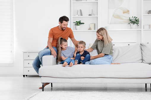 Happy family spending time together on sofa at home