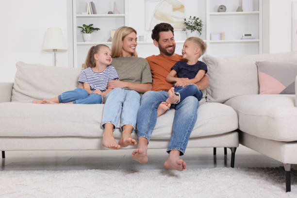istock Happy family spending time together on sofa at home 1905742437