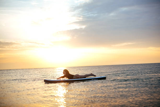 istock Woman relaxing on a paddle board 1905767556