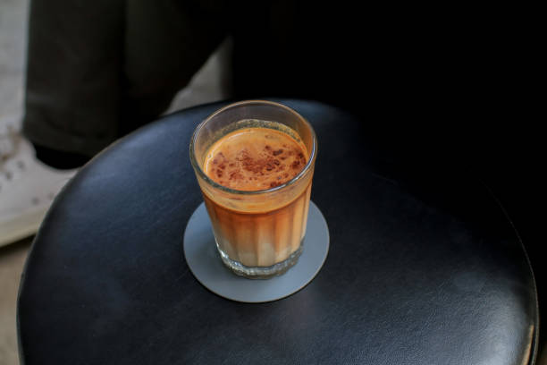 Dirty Coffee, Espresso shot mixed with cold fresh milk on black table in coffee shop cafe and restaurant. Morning breakfast.