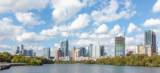 skyline of Austin in early morning light with mirroring city in the colorado river, Texas, USA