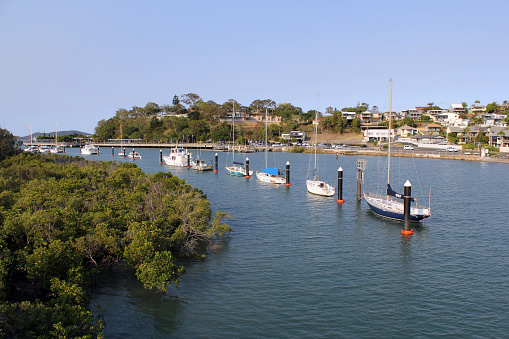 Gladstone, Queensland, Australia - October 22, 2023: Yachts moored in Auckland Creek with East Shores in the background