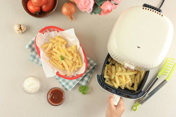 istock Female Hand Take Out Airfryer Tray Machine Ccooking. 1905787306