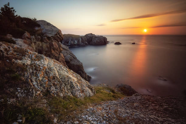 istock Coastal rocks at sunset seascape 1905807892