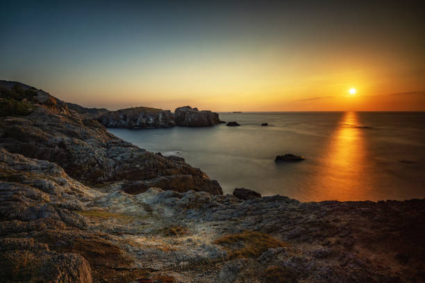 istock Coastal rocks at sunset seascape 1905807893