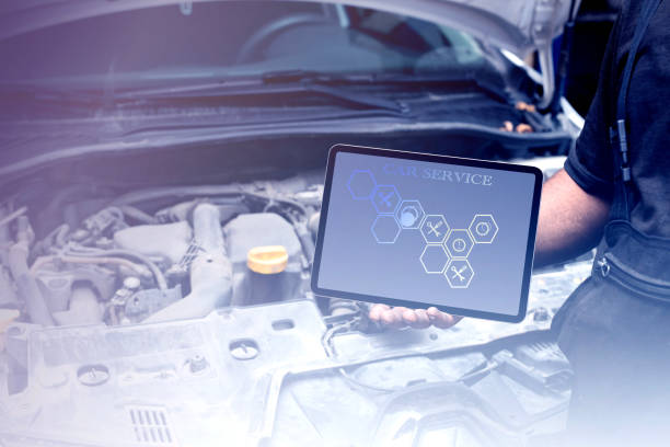 istock Mechanic using tablet checking up on car engines parts for fixing and repair 1905825751