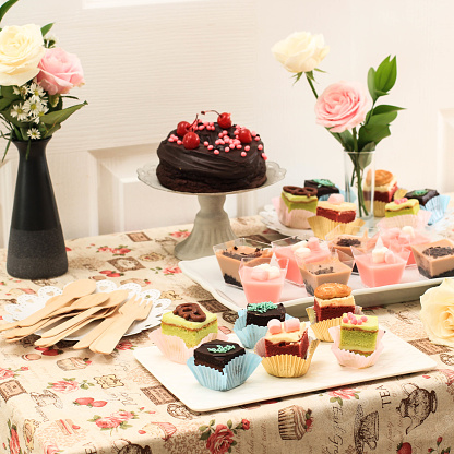Various Slice Cake Setting for Dessert Table at Party, Decorated with Fresh White and Pink Rose