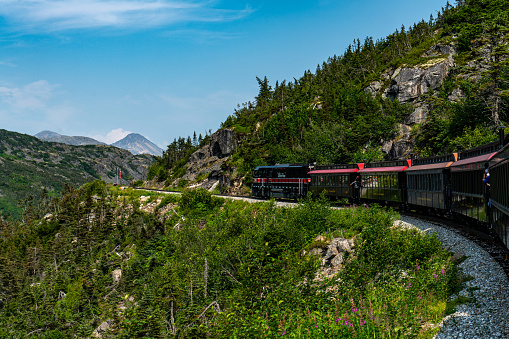 Skagway, Alaska - July 30, 2023: Tourists are enjoying the view from train. White Pass Summit excursion tour train, Alaska, USA.