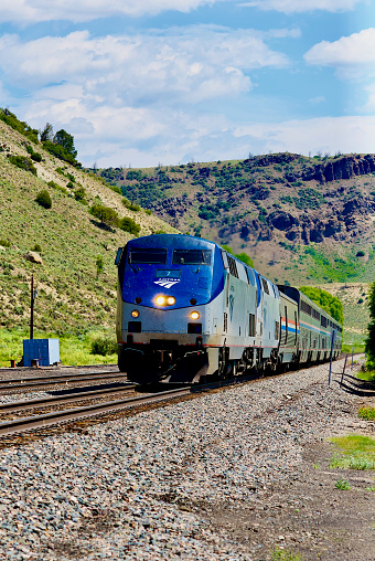 Hot Sulphur Springs, Colorado, USA - July 18, 2023: The westbound Amtrak “California Zephyr” overnight passenger train passes through Hot Sullphur Springs on a summer afternoon.