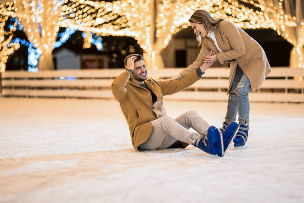 istock Happy couple having fun ice skating. 1905927645