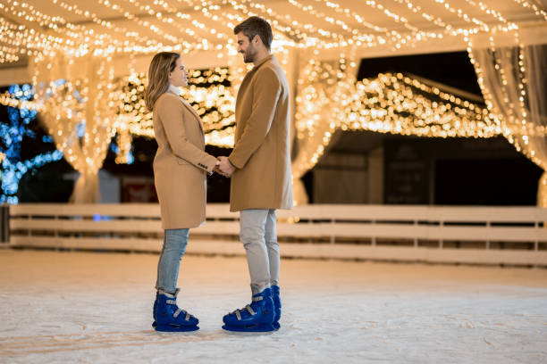 istock Happy couple ice skating on a holiday. 1905929687