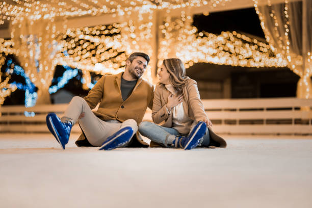 istock Happy couple having fun ice skating. 1905933812