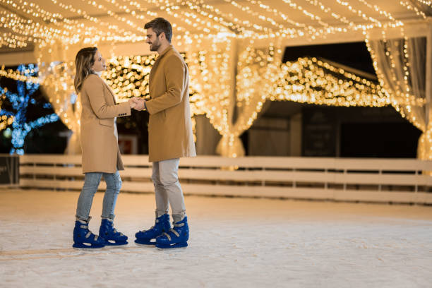 istock Happy couple ice skating on a holiday. 1905940481