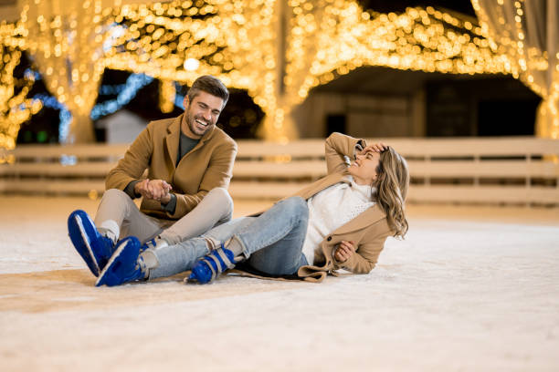 istock Happy couple having fun ice skating. 1905941492