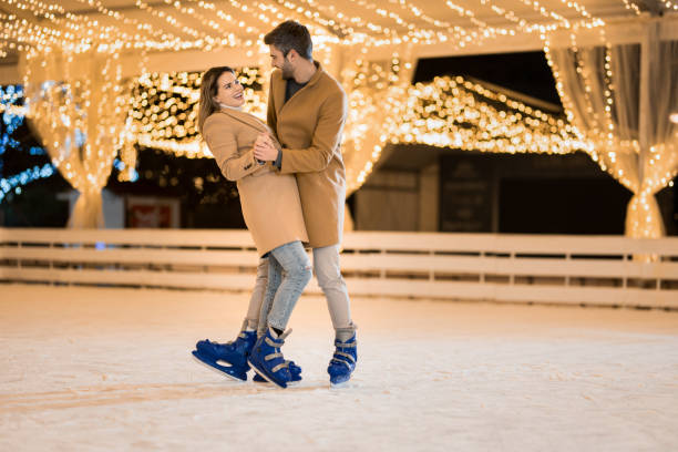 istock Happy couple having fun ice skating. 1905942010
