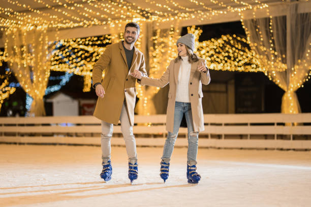 istock Happy couple having fun ice skating. 1905945059