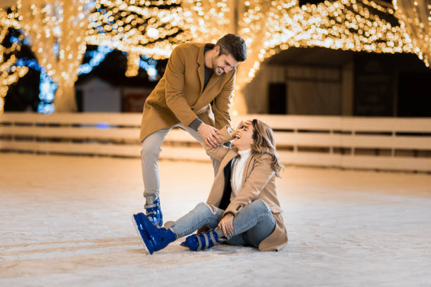 istock Happy couple having fun ice skating. 1905946590