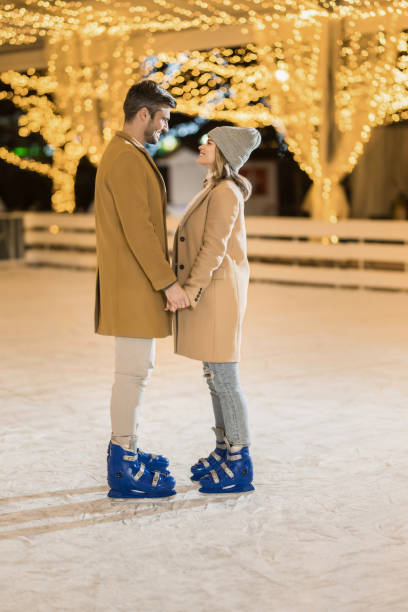 istock Lovely couple ice skating on a holiday. 1905947635