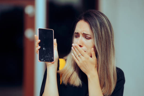 istock Sad Woman Crying for her Broken Expensive Smartphone Screen 1906000459
