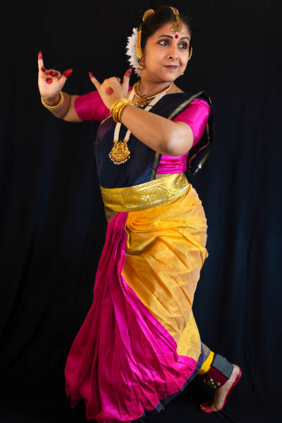 istock Female Indian classical dancer in dance posture on dark background 1906039429