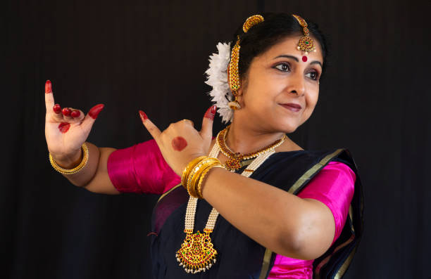 istock Woman dancer perform the Indian classical dance Bharatanatyam on black background 1906039946