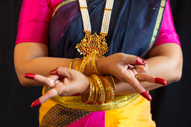 Woman Indian classical dancer perform Bharatanatyam mudra on black background
