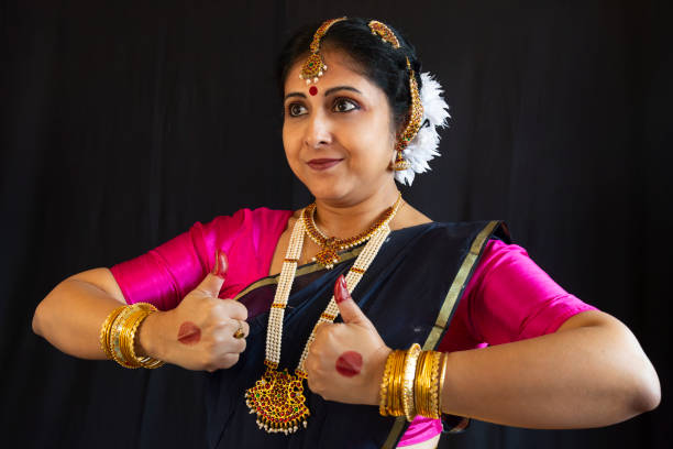 istock Woman dancer perform the Indian classical dance Bharatanatyam on black background 1906041492