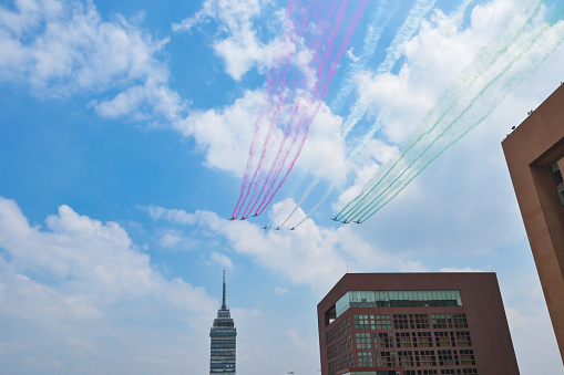 Mexican military planes in parade formation, Mexican independence day, colorful smoke trails. Military parade in Mexico to celebrate Independence Day.