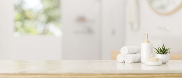 Towels, a shampoo bottle, a soap, a potted plant, and copy space on a luxury white tabletop in a modern white bathroom. 3d render, 3d illustration