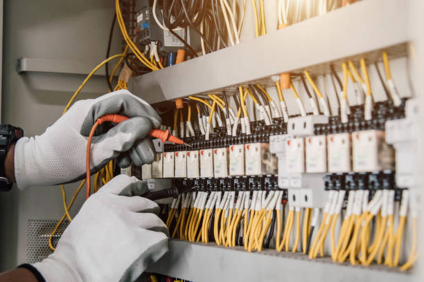 istock Electrician engineer tests electrical installations and wires on relay protection system. 1906119315