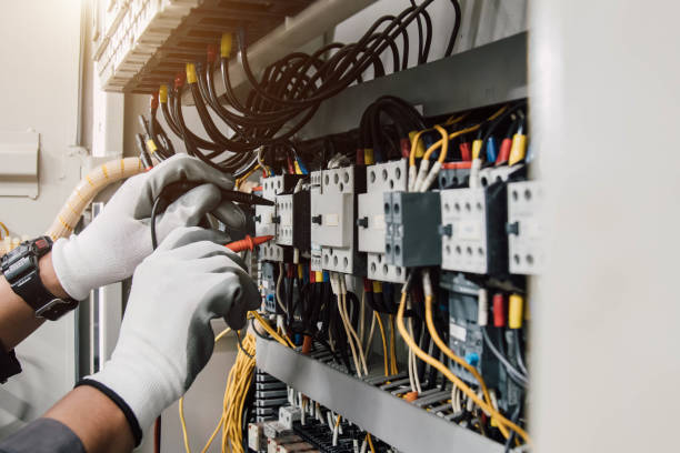 istock Electrician engineer tests electrical installations and wires on relay protection system. 1906119317