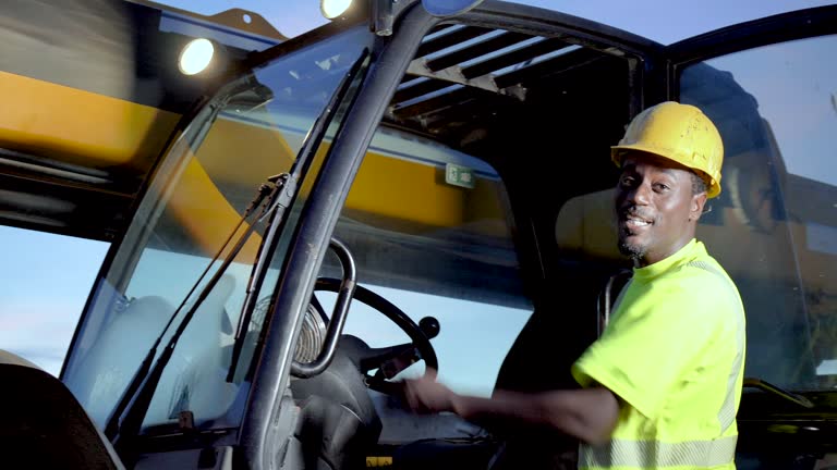 African-American worker exits construction vehicle