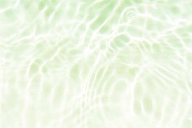 istock Bluewater waves on the surface ripples blurred. Defocus blurred transparent blue colored clear calm water surface texture with splash and bubbles. Water waves with shining pattern texture background. 1906140938