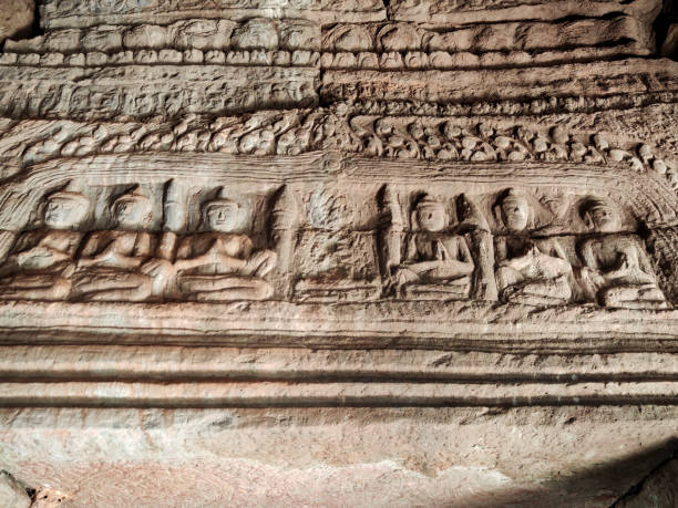 Apsara carvings at the majestic Bayon, a richly decorated Khmer temple at Angkor in Cambodia. Built in the late 12th or early 13th century as the state temple of the King Jayavarman VII, the Bayon stands at the centre of Jayavarman's capital, Angkor Thom.The Bayon's most distinctive feature is the multitude of serene and smiling stone faces of The Buddha.