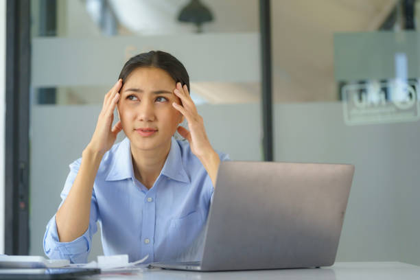 istock Asian businesswoman working on a laptop computer, stressed has a headache, and thinks hard from work at the office. 1906175129