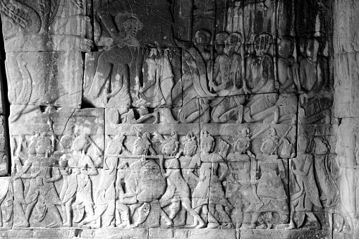 Carvings at the majestic Bayon, a richly decorated Khmer temple at Angkor in Cambodia. Built in the late 12th or early 13th century as the state temple of the King Jayavarman VII, the Bayon stands at the centre of Jayavarman's capital, Angkor Thom.\nThe Bayon's most distinctive feature is the multitude of serene and smiling stone faces of The Buddha.