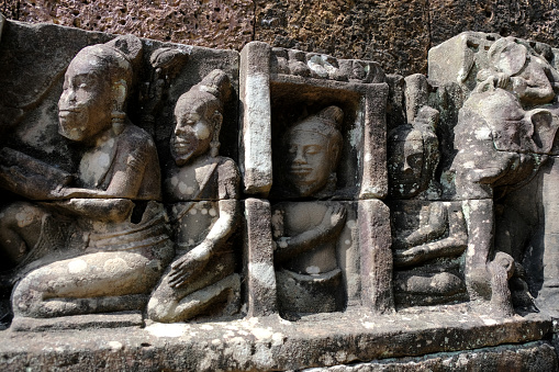 Sculptures at the Terrace of the Leper King, located in the northwest corner of the Royal Square of Angkor Thom, Cambodia.\nIt was built in the Bayon style under Jayavarman VII.