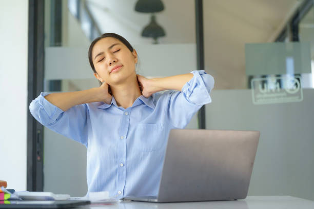 istock Businesswoman working in an office stretches to relax from work during breaks. 1906183479