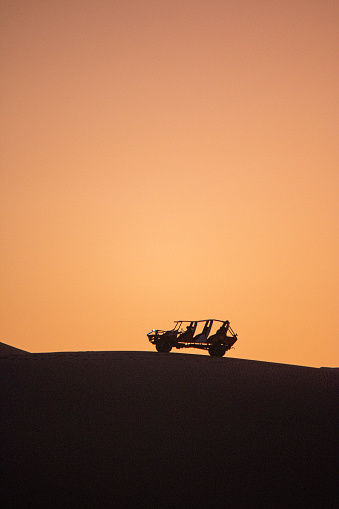 Dune buggy on top of sand dune in Huacachina, Ica, Perú