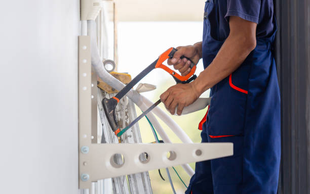 istock Technicians man using a hacksaw to cut a pipe, Air conditioning technicians install new air conditioners in homes, Repairman fix air conditioning systems 1906191372