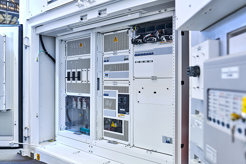 Side view of electromechanical and electric control panel switchgear.