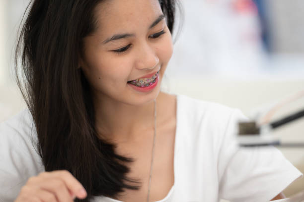 istock Teenage girls students studying with hand robot model 1906208665
