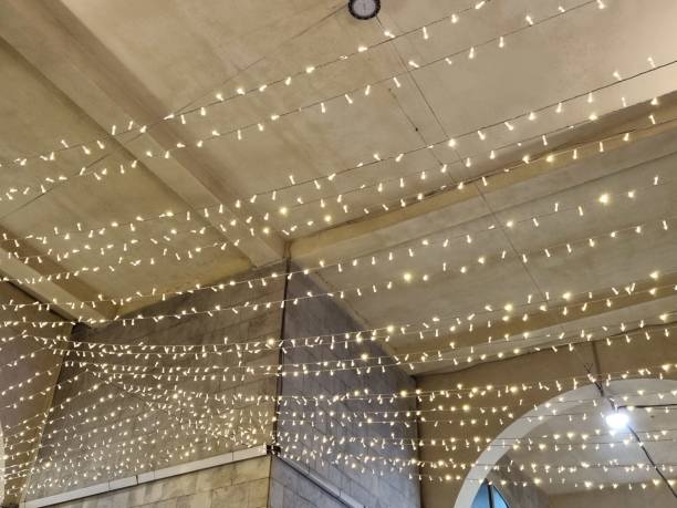 istock Electric garland hanging on a building 1906211233