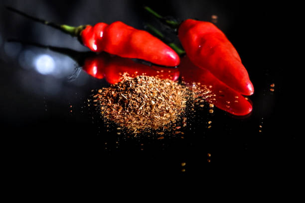 istock powder from chili pepper isolated on black background, dried powdered chili pepper 1906219980