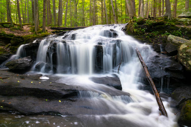 close up on flowing waterfall cascade in the river