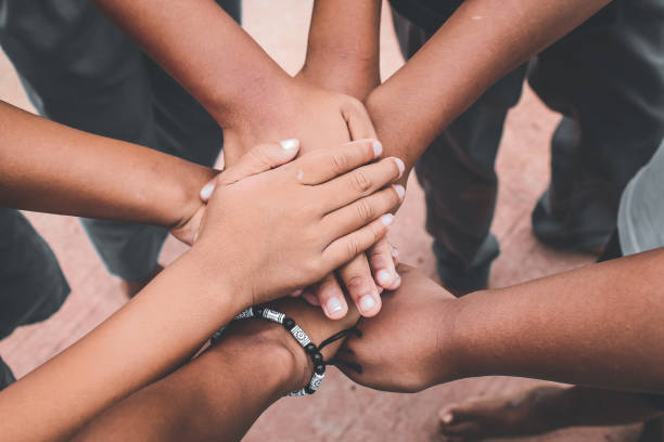 istock Teamwork, hands together.  close up of a pile of boys' hands while playing.  unity concept 1906250466