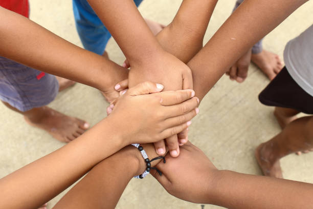 istock Teamwork, hands together.  close up of a pile of boys' hands while playing.  unity concept 1906250469