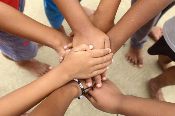 istock Teamwork, hands together.  close up of a pile of boys' hands while playing.  unity concept 1906250479