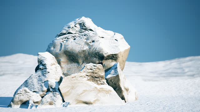 A huge stone in the middle of a snowy desert